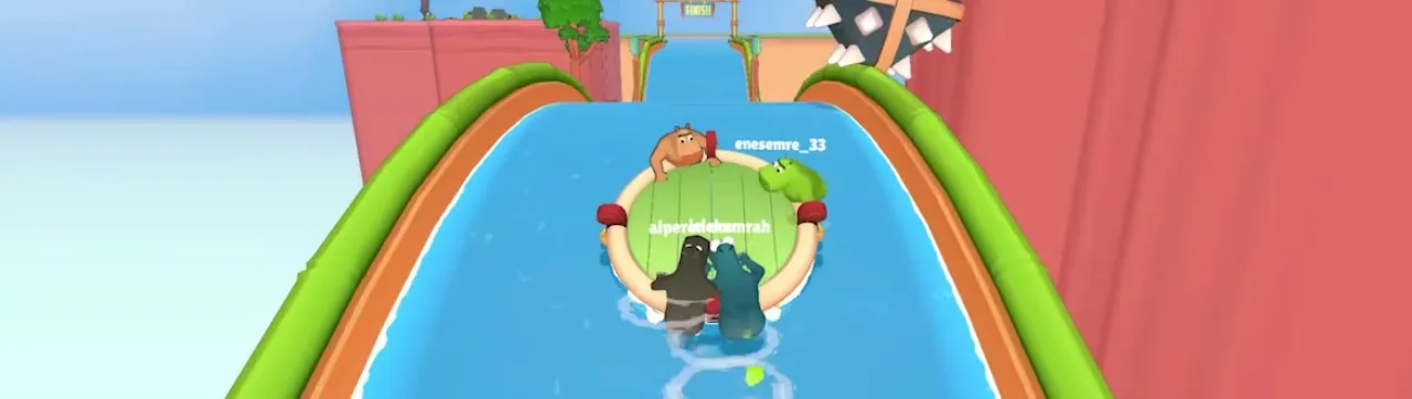 Four players on a round raft approaching a FINISH gate on an elevated teal water track with usernames visible