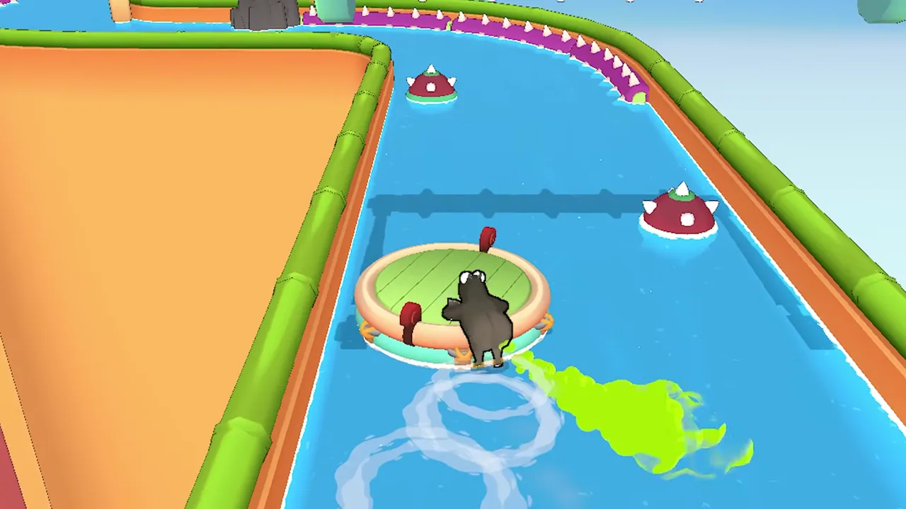 A grey hippo on a round raft leaves a long green cloud behind on the right while two red spiked floats sit ahead in the canal